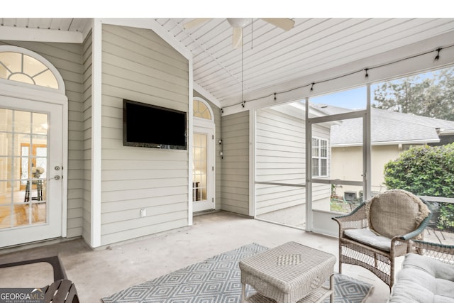 sunroom with ceiling fan and vaulted ceiling