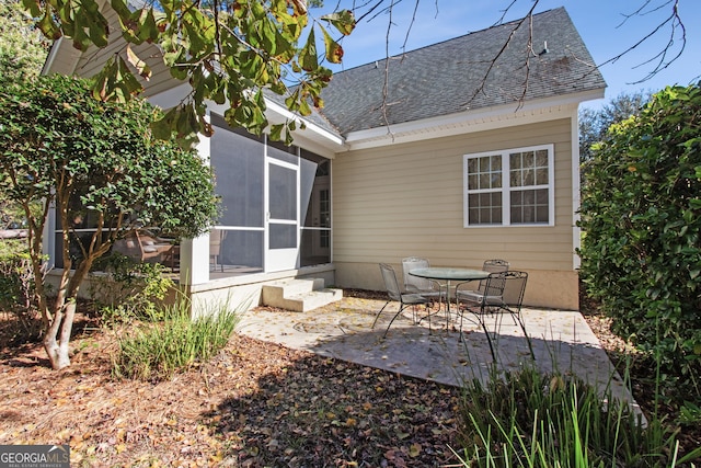 rear view of property with a patio and a sunroom