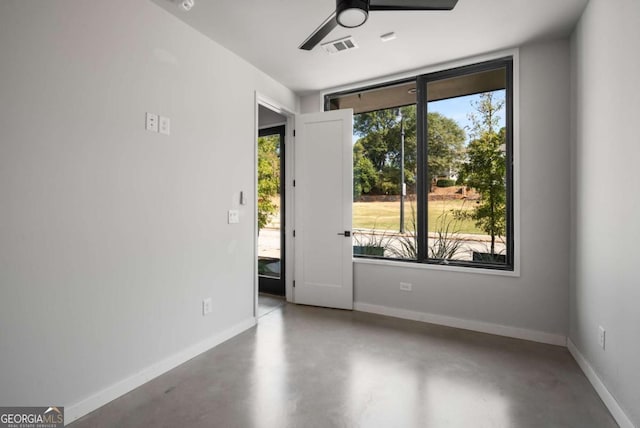 spare room with concrete flooring and ceiling fan