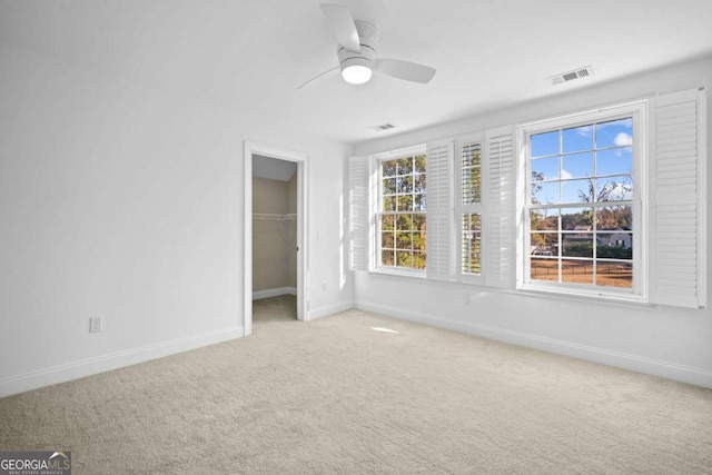 22 Lazy Hammock Ct, Savannah, GA 31419 - unfurnished bedroom featuring a walk in closet, carpet floors, ceiling fan, and a closet