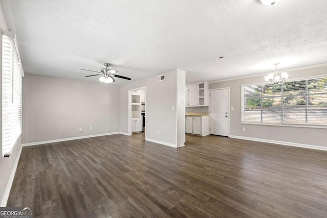 unfurnished living room with ceiling fan with notable chandelier, a textured ceiling, and dark hardwood / wood-style flooring