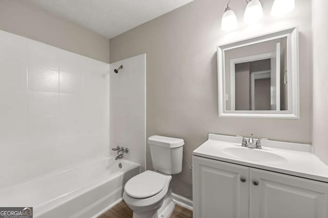 full bathroom featuring hardwood / wood-style floors, bathtub / shower combination, vanity, and toilet