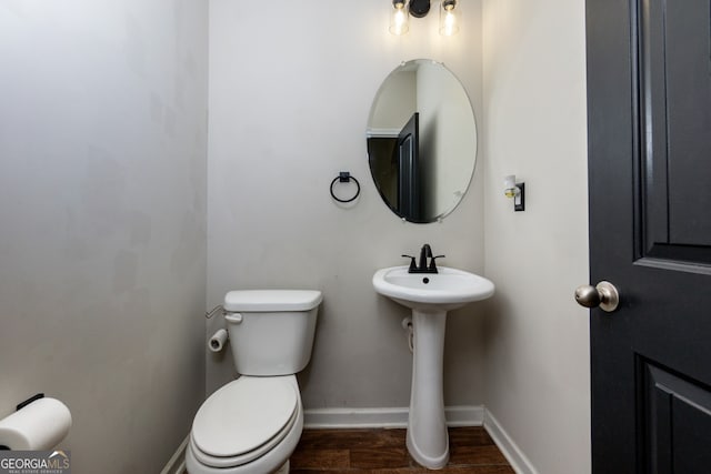 bathroom featuring hardwood / wood-style floors and toilet