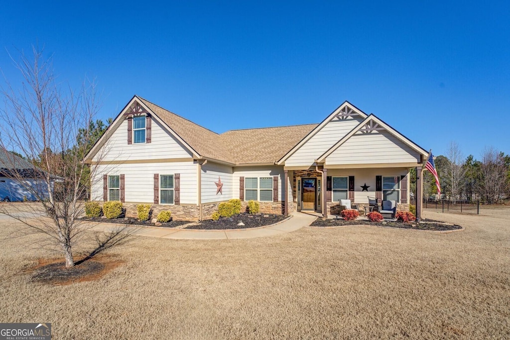 view of front of property featuring a front lawn and a porch