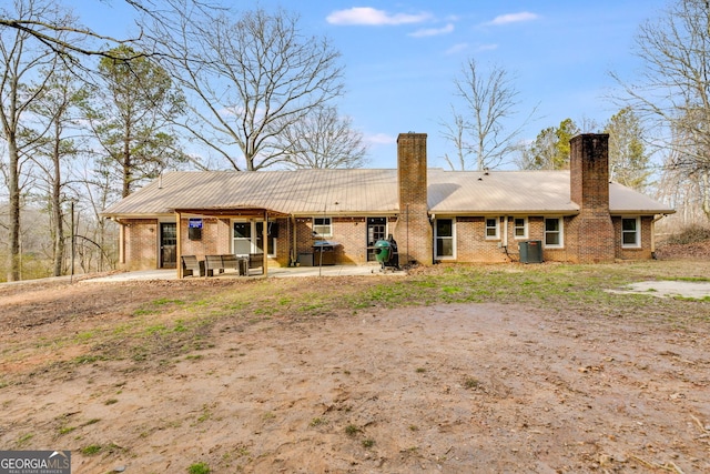 back of property featuring central AC and a patio area