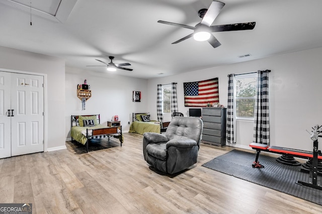 living room featuring ceiling fan and light wood-type flooring