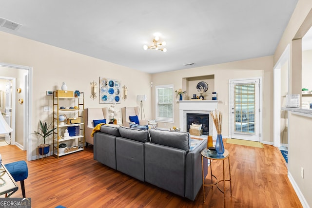 living room with wood-type flooring and a notable chandelier