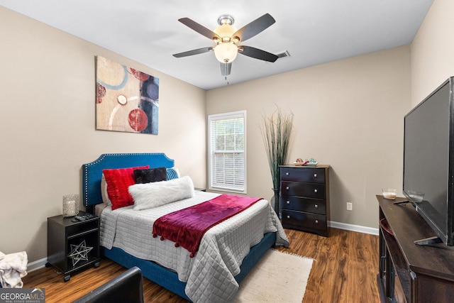 bedroom with ceiling fan and dark hardwood / wood-style floors