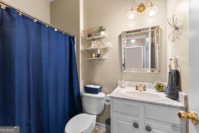 bathroom featuring toilet and vanity