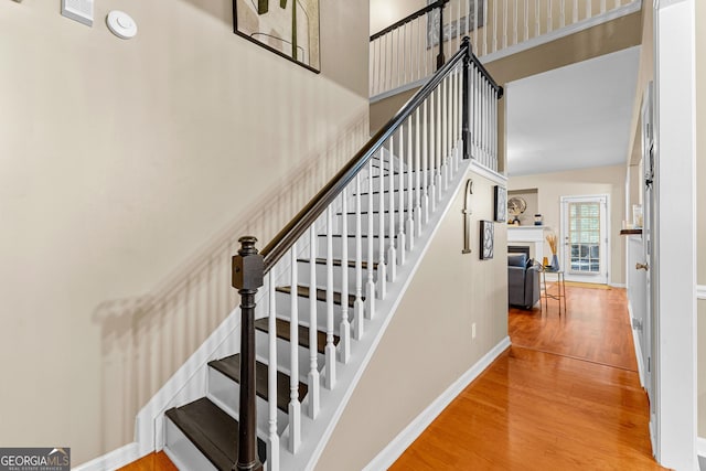 staircase featuring wood-type flooring