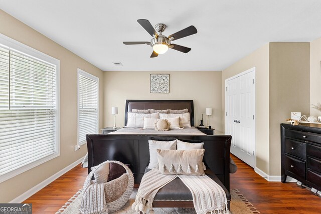 bedroom featuring ceiling fan and dark wood-type flooring