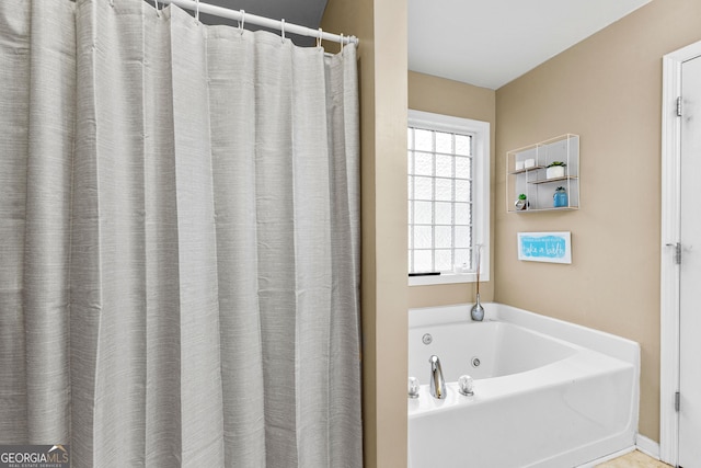 bathroom featuring a tub to relax in