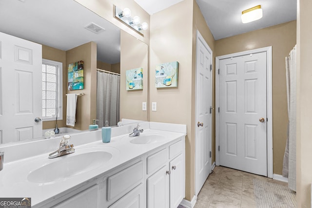 bathroom with tile patterned floors and vanity