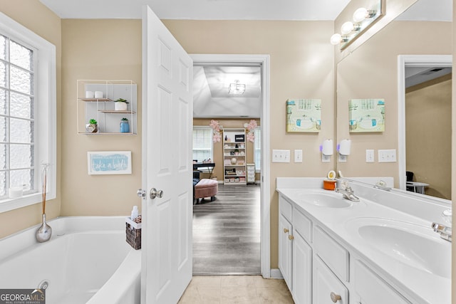 bathroom featuring a tub, tile patterned floors, and vanity