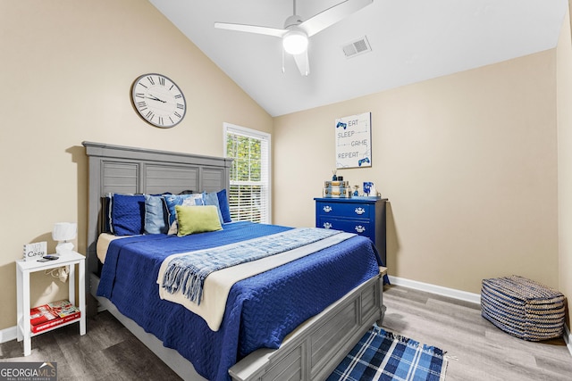 bedroom featuring ceiling fan, lofted ceiling, and hardwood / wood-style flooring