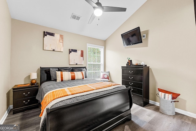 bedroom with ceiling fan, hardwood / wood-style floors, and lofted ceiling