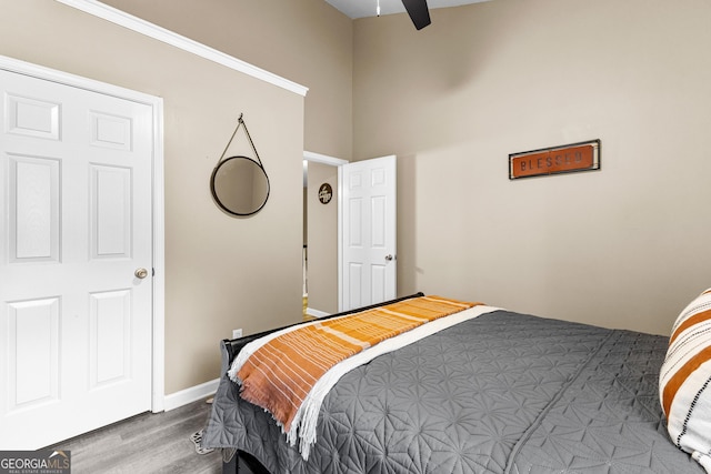 bedroom with ceiling fan and hardwood / wood-style flooring