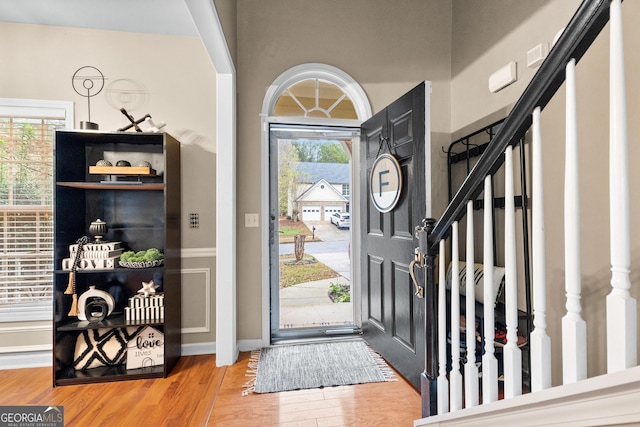 foyer featuring plenty of natural light and hardwood / wood-style flooring