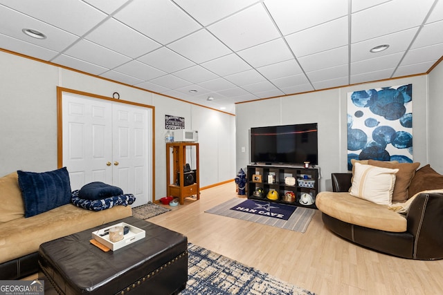 living room with crown molding and wood-type flooring