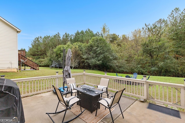 view of patio / terrace with a grill, an outdoor fire pit, and a trampoline