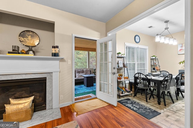 dining space with a fireplace and light hardwood / wood-style floors