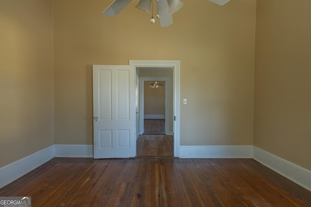 unfurnished room featuring ceiling fan and dark hardwood / wood-style floors