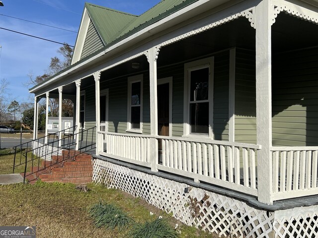 exterior space with a porch and central AC