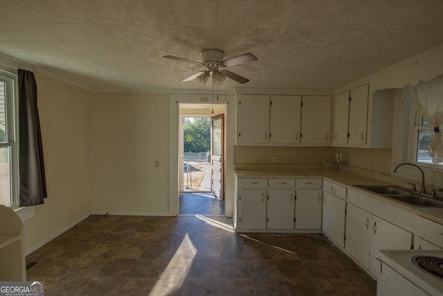 kitchen featuring ceiling fan, white cabinets, and sink