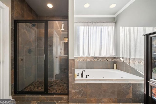 bathroom featuring ornamental molding and independent shower and bath