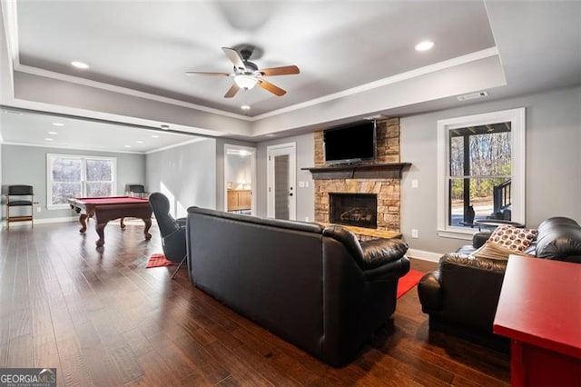 living room with pool table, crown molding, ceiling fan, dark wood-type flooring, and a fireplace