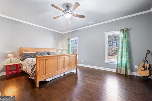 bedroom featuring ceiling fan, ornamental molding, and dark hardwood / wood-style floors