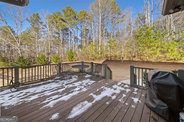 wooden deck featuring a grill