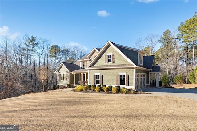 view of front of house with a front yard and a garage