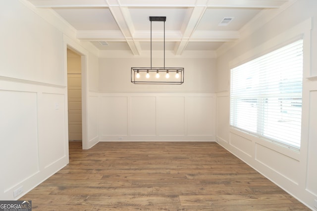 unfurnished dining area with hardwood / wood-style flooring, beamed ceiling, and coffered ceiling