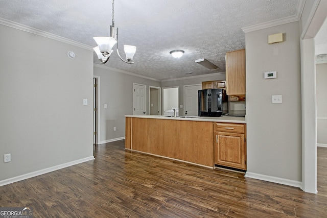 kitchen with a chandelier, black appliances, kitchen peninsula, pendant lighting, and a textured ceiling