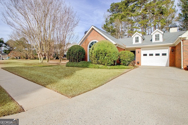 view of front of property with a garage and a front lawn