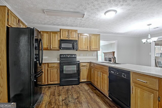 kitchen featuring sink, ornamental molding, dark hardwood / wood-style floors, a chandelier, and black appliances