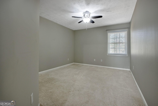 carpeted empty room featuring a textured ceiling and ceiling fan