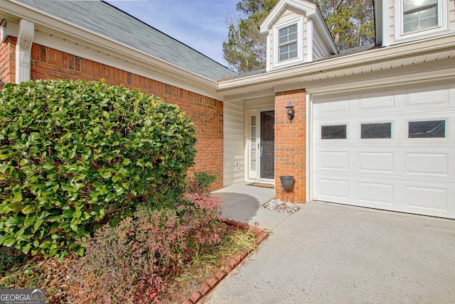 doorway to property with a garage