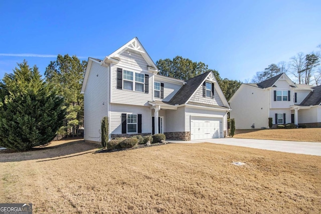 view of front of property featuring a garage and a front lawn