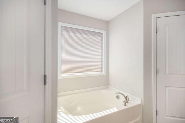 bathroom featuring a tub to relax in