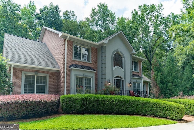 colonial-style house with a front yard