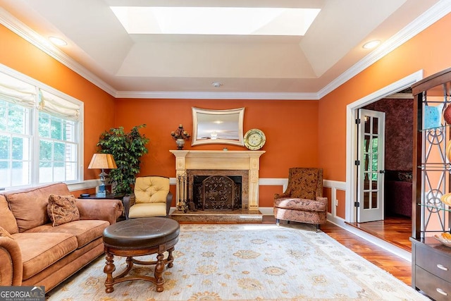 living room featuring a raised ceiling, crown molding, and hardwood / wood-style floors