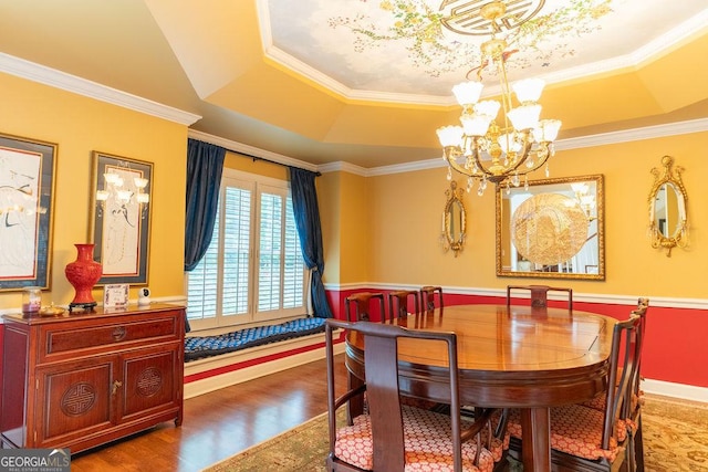 dining room featuring a notable chandelier, a tray ceiling, crown molding, and dark hardwood / wood-style floors