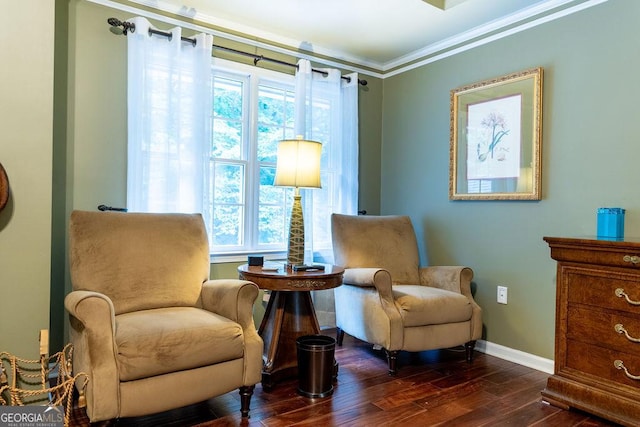 sitting room with crown molding and dark hardwood / wood-style floors