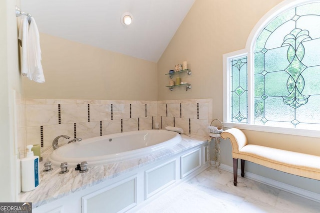 bathroom featuring lofted ceiling and a bathing tub