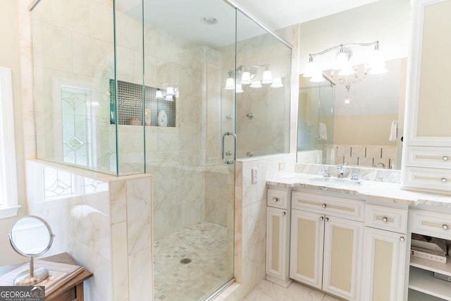 bathroom with a chandelier, an enclosed shower, and vanity