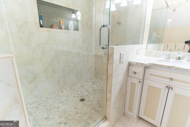 bathroom featuring walk in shower and vanity