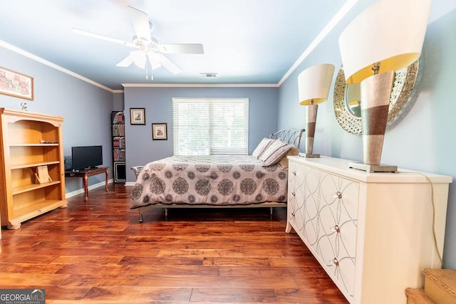 bedroom featuring ornamental molding, ceiling fan, and dark hardwood / wood-style floors