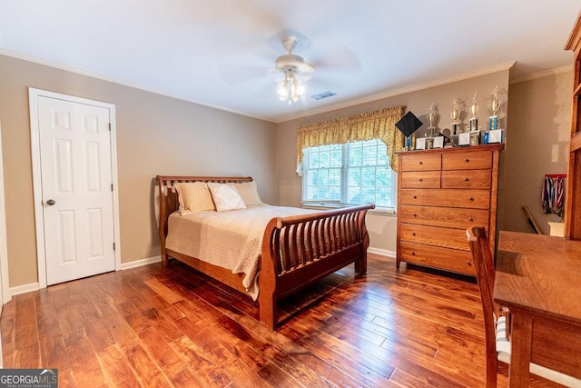 bedroom featuring hardwood / wood-style flooring, ceiling fan, and ornamental molding